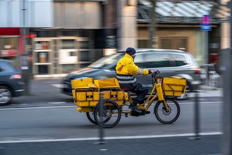 Postman on tricycle e-bike, Bochum, North Rhine-Westphalia, Germany, Europe