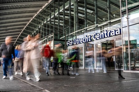 Station forecourt of Utrecht Centraal station, people on their way to, from the station,