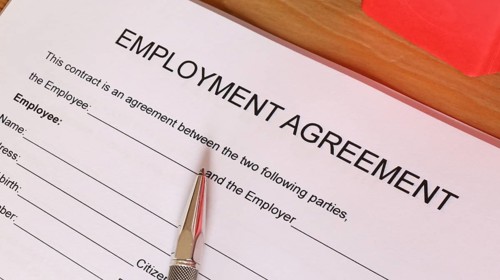 Symbolic image: Blank form of an employment contract on a desk (English)