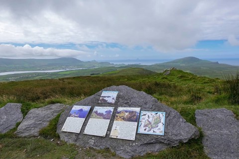 Signposts to the Skellig Rocks lying in the haze on the horizon, County Kerry, Republic of Ireland