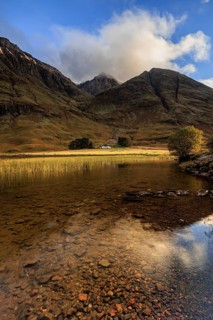 Mountains reflected in loch, evening light, cloudy mood, Achnambeithach Cottage, Loch Achtriochtan,