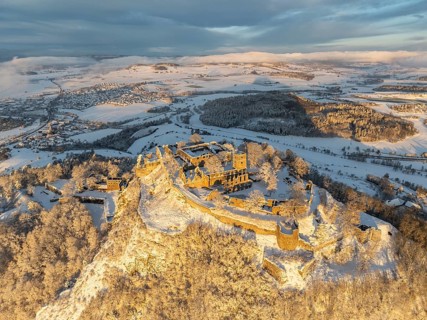 Aerial view of the snow-covered Hegau volcano Hohentwiel with Germany's largest castle ruins on a