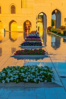 Marble-framed flowerbeds in front of the Royal Opera House in the evening light, Muscat, Arabian