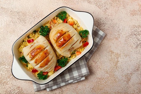 Stuffed squid carcasses, baked in the oven, fried, with couscous, top view, homemade, no people