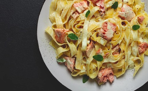 Tagliatelle pasta, in cream sauce with salmon, homemade, no people