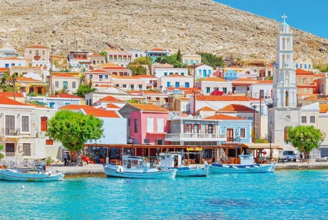 View of Emporio harbour and Saint Nicholas church in the distance, Halki Island, Dodecanese