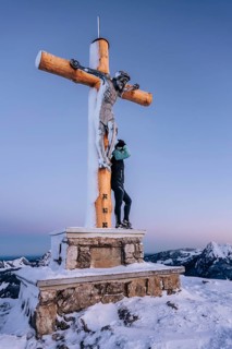 Summit bliss in the snow-covered winter landscape in the Tannheimer Tal in the Alps on the