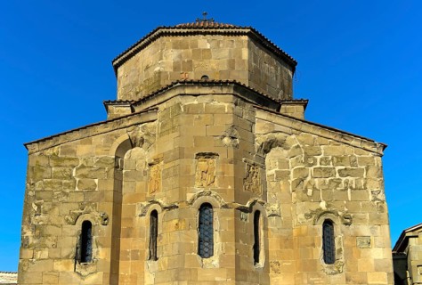 East façade of the Dzhvari Cross Church with three architectural bas-reliefs depicting the church