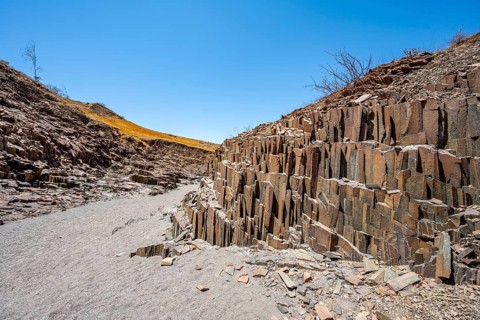 Dry river valley with basalt rocks, rock formation Organ Pipes, Damaraland, Kunene, Namibia, Africa