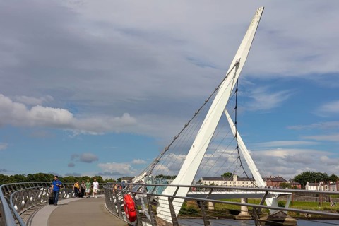 Side view of a modern bridge under a clear blue sky, Londonderry