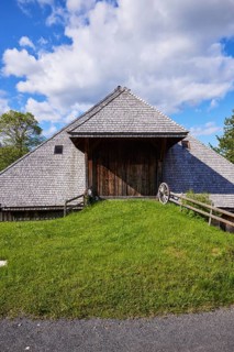 Driveway into a Black Forest house with an old wagon wheel of the Resenhof Farm Museum in the