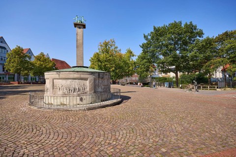 Brine spring on the Salzhof square under a blue, cloudless sky in the city centre of Bad Salzuflen,