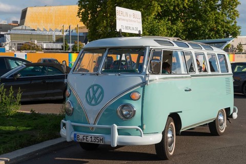 Mint green VW vintage bus on a street in Berlin, retro style, city tour with VW Bulli, VW T1,