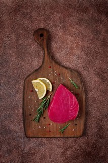Fresh red tuna fillet, for steak, raw, top view, on a cutting board, no people