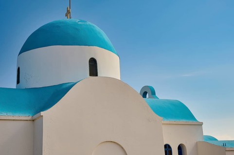 Side view of a white-blue church under a blue sky, Church of Profitis Ilias, above Nikia, Nikia,