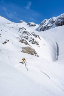 Lone ski tourer in mountain landscape with snow, ascent to Wildstrubelhütte, Bernese Alps,