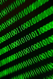 Digital green binary numbers with blurring, symbolises data stream effect