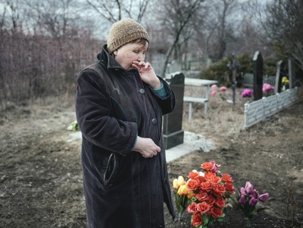 Ludmilla (68) mourns her grandson, who died at the front a month earlier, at the cemetery. The