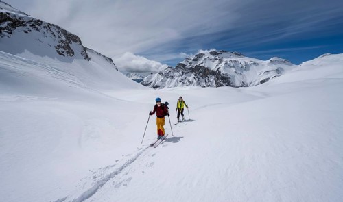 Ski tourers in a mountain landscape with snow, summit Wildhorn in the background, ascent to