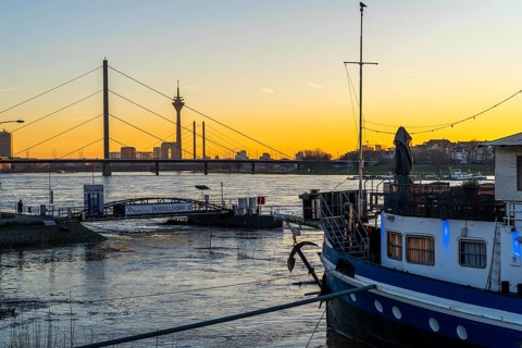 Sunset on the Rhine near Düsseldorf, skyline of the city centre with Rhine Tower, Rheinkniebrücke,