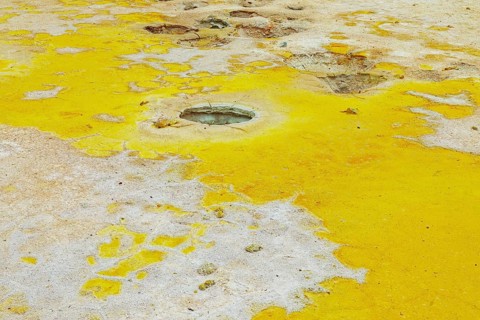 Splashes of sulphur colouring Stefanos crater ground, Nisyros Island, Dodecanese Islands, Greece,