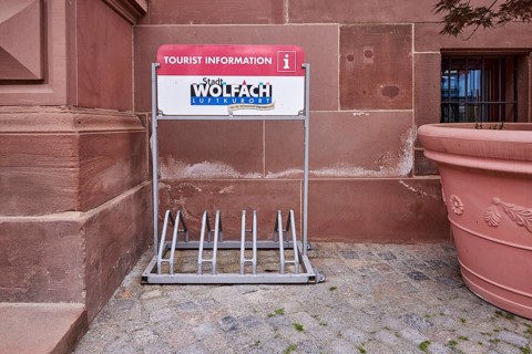 Bicycle stand with advertising City of Wolfach, tourist information centre, flower bucket, main