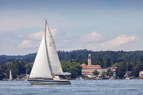 Sailing boat on Lake Constance in front of the luxury hotel Bad Schachen, Lindau, Lake Constance,