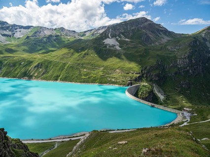Dam of the Moiry lake, Lac de Moiry, turquoise glacial water, parking lot and restaurant at the