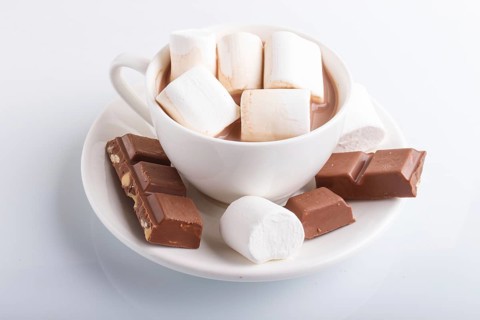 A cup of hot cocoa with marshmallow and milk chocolate isolated on white.isolated on white, closeup