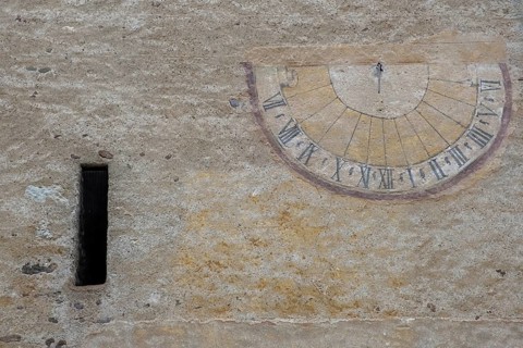 Sundial on a weathered house facade, Kaltern, South Tyrol, Italy, Europe