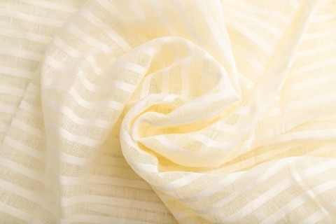 Fragment of white linen tissue. Top view, flat lay, natural textile background and texture. wave