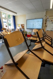 Classroom of a fourth grade, after school, the building is older but in good condition, modern