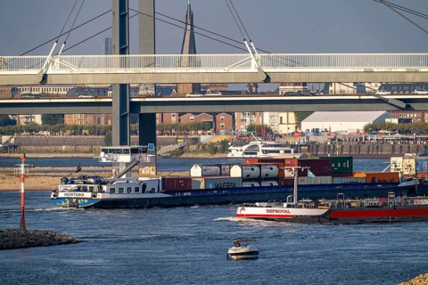 Cargo ships on the Rhine near Düsseldorf, bridge over the Media Harbour, Oberkassler Rhine Bridge,