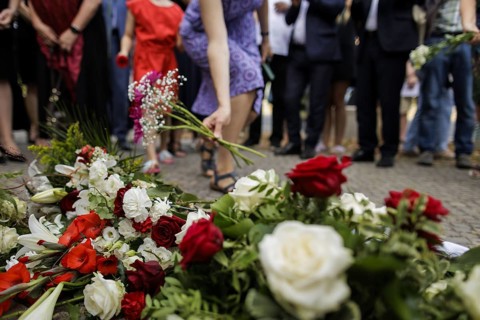 People lay flowers during a commemoration event on the anniversary of the German invasion of Poland