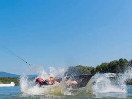 Man makes somersault with wakeboard, fall, water ski and wakepark