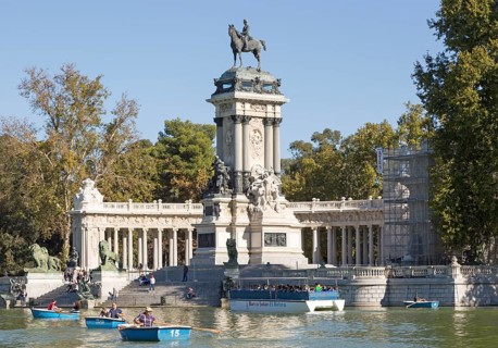 Rowing boats in boating pond of Estanque, El Retiro park, Madrid, Spain, monument to King Alfonso