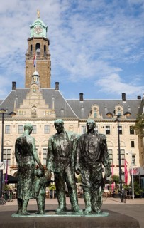A sculpture in front of the historic Stadhuis Rotterdam, Netherlands constructed 1920 with Mari