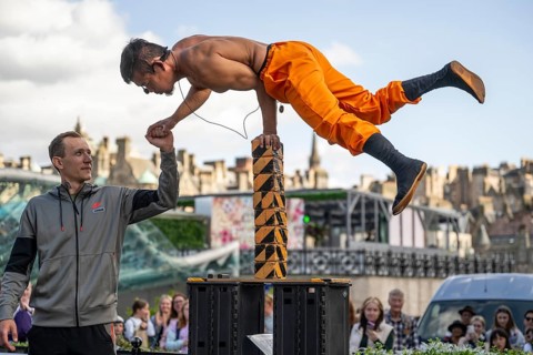 Street performers and spectators, acrobatic performance, Prince Street, world's largest cultural