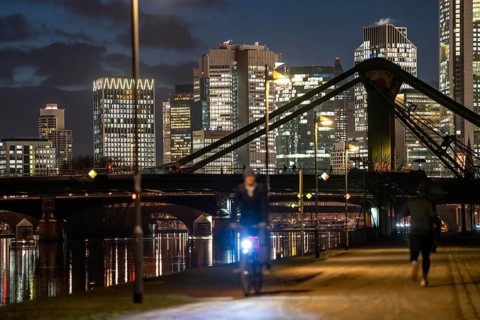 Skyline of the city centre of Frankfurt am Main, cyclist with light on the cycle path, pavement,
