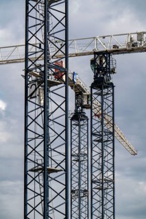 Construction cranes on two large construction sites, construction of office buildings in