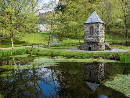 Springtime at the park of baroniet Rosendal, pond with tower, old castle, Rogaland, Norway, Europe