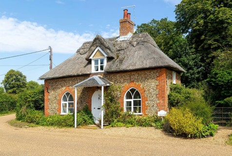 Flint and thatched historic country cottage former estate worker's home, Sutton, Suffolk, England,