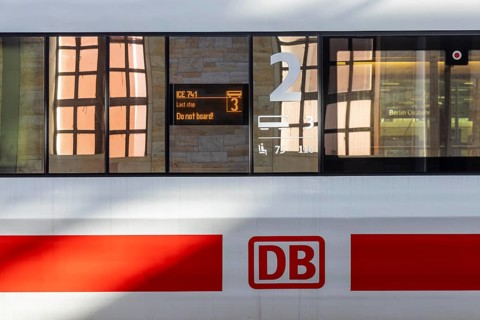 ICE with Deutsche Bahn AG logo, reflection in the train window. Display with the inscription