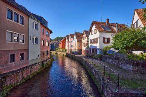 River Mud with houses in the evening sun in Amorbach, Lower Franconia, Miltenberg district,