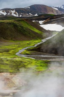 Colourful volcanic landscape with hills and snow, volcanic steaming hot springs, Laugavegur