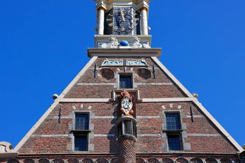 City coat of arms with unicorn and post horn on the historic Hoofdtoren defence defence tower in