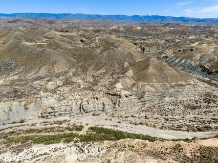 Wide valley in dry mountain landscape with sparse vegetation, aerial view, Tabernas Desert,