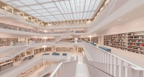 Modern, bright library with open staircases and many bookshelves in a symmetrical arrangement,