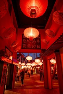 Visitors, Chinese neighbourhood with red lanterns and traditional signs with characters,