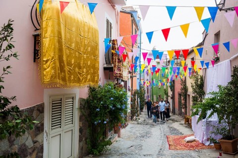 Decorated alley and celebrating people, feast of the Madonna of Regnos Altos, Bosa, district of